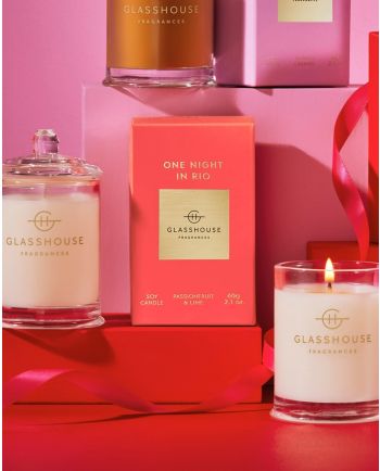 Glasshouse Fragrances One Night in Rio candles and gift boxes displayed on pink gift boxes with ribbon accents.
