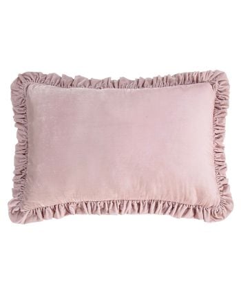 Blush pink velvet lumbar pillow with ruffled trim border.