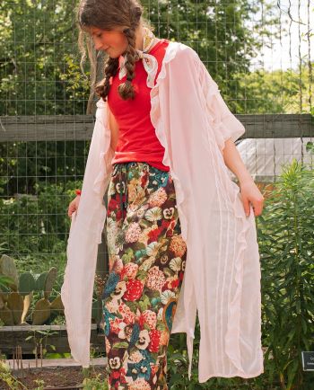 Sheer cream ruffle duster layered over a lace cami and light-wash jeans.